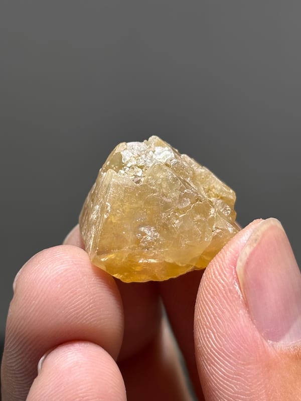 Honey scheelite with frosted top from Xuebaoding, Sichuan, China, close-up of the crystal faces
