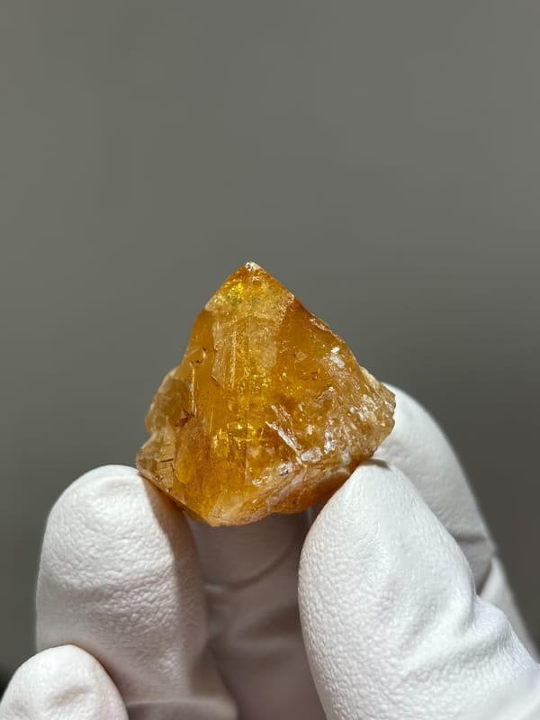 Honey scheelite with complete tip from Xuebaoding, Sichuan, China, close-up of the crystal faces