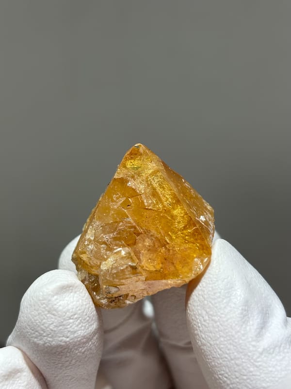 Honey scheelite with complete tip from Xuebaoding, Sichuan, China, reverse side