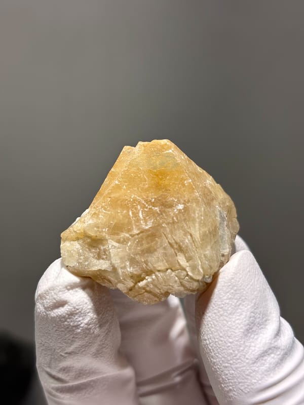 Honey scheelite with small fluorite from Xuebaoding, Sichuan, China, close-up of the crystal faces