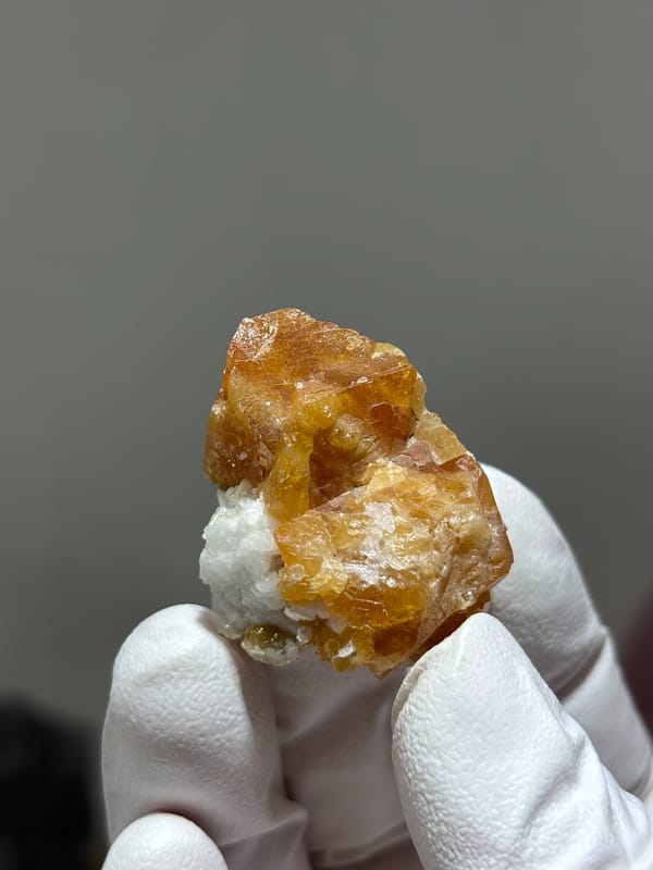 Honey scheelite in partly columnar habit from Xuebaoding, Sichuan, China, close-up of the crystal faces