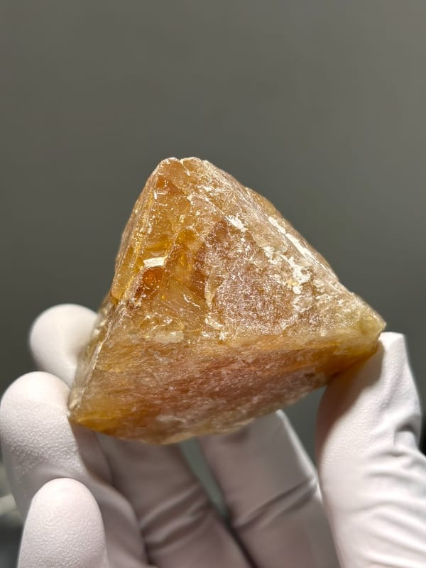 Large honey scheelite from Xuebaoding, Sichuan, China, close-up of the crystal faces