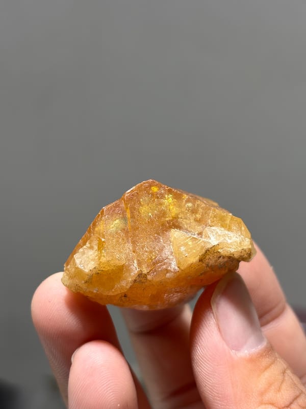 Honey-orange scheelite floater from Xuebaoding, Sichuan, China, close-up of the crystal faces