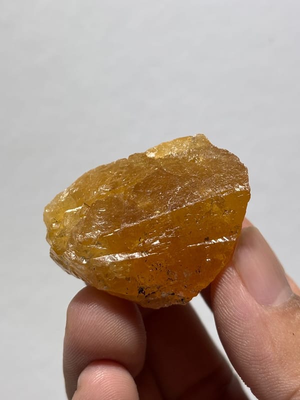 Honey-orange scheelite crystal from Xuebaoding, Sichuan, China, close-up of the crystal faces