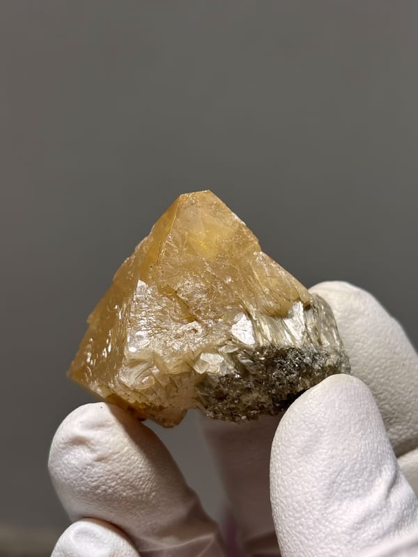 Honey-orange scheelite crystal from Xuebaoding, Sichuan, China, close-up of the crystal faces