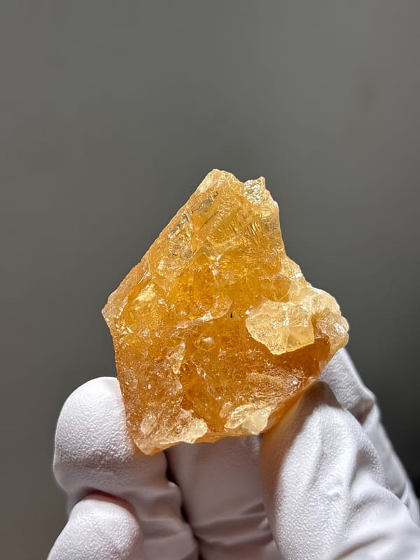 Honey-orange scheelite crystal from Xuebaoding, Sichuan, China, close-up of the crystal faces