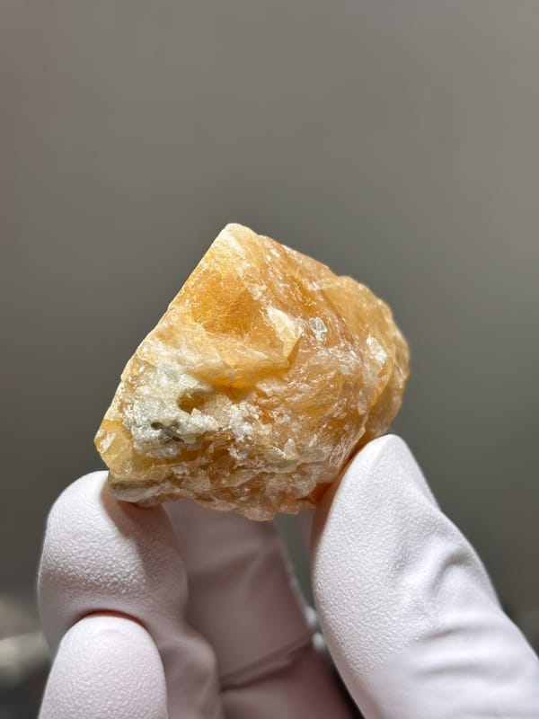 Honey-orange scheelite from Xuebaoding, Sichuan, China, close-up of the crystal faces