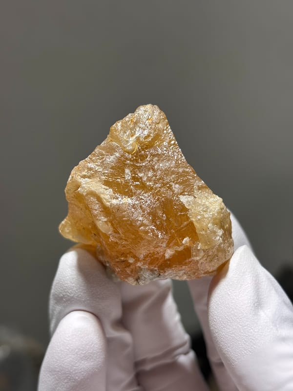 Honey-orange scheelite crystal from Xuebaoding, Sichuan, China, close-up of the crystal faces