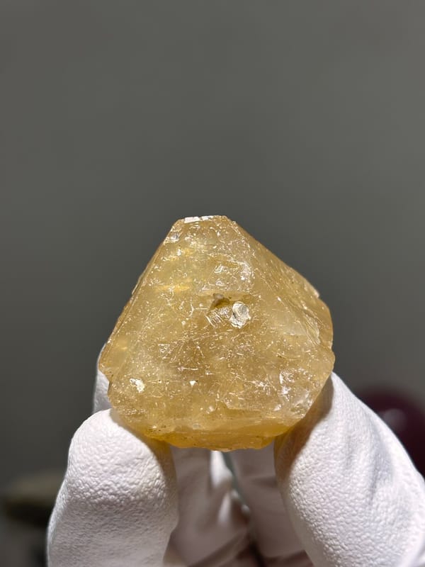 Honey-orange scheelite crystal from Xuebaoding, Sichuan, China, close-up of the crystal faces