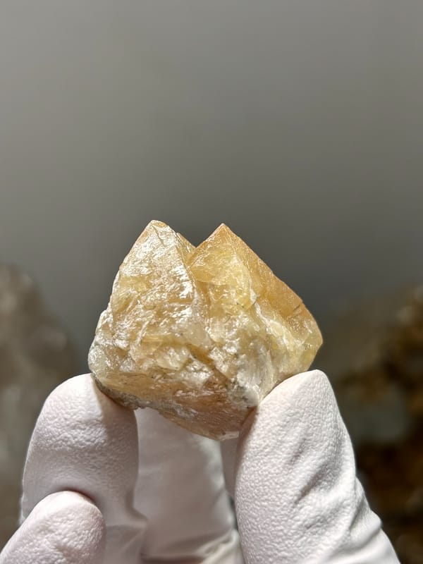 Honey-orange scheelite crystal group from Xuebaoding, Sichuan, China, close-up of the crystal faces