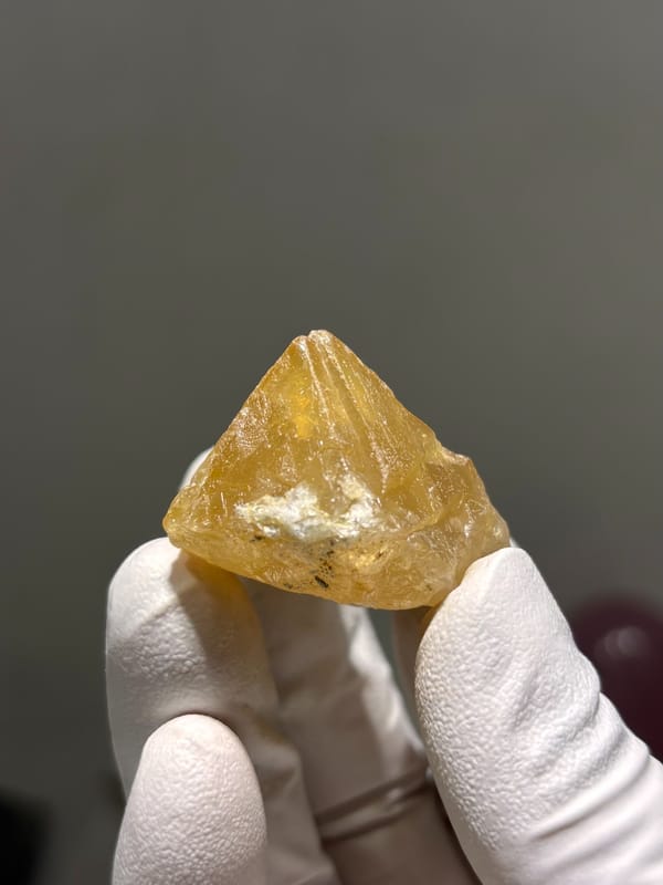 Honey-orange scheelite crystal from Xuebaoding, Sichuan, China, close-up of the crystal faces