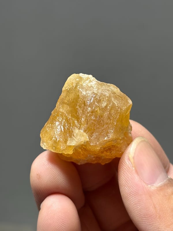 Honey-yellow scheelite crystal from Xuebaoding, Sichuan, China, close-up of the crystal faces