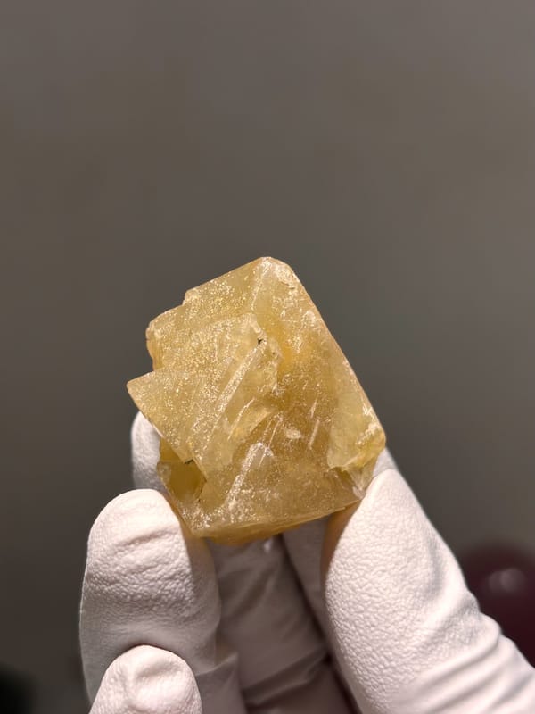 Honey-yellow scheelite crystal from Xuebaoding, Sichuan, China, close-up of the crystal faces