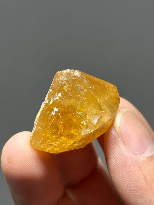 Orange scheelite crystal with white calcite from Xuebaoding, Sichuan, China, top view