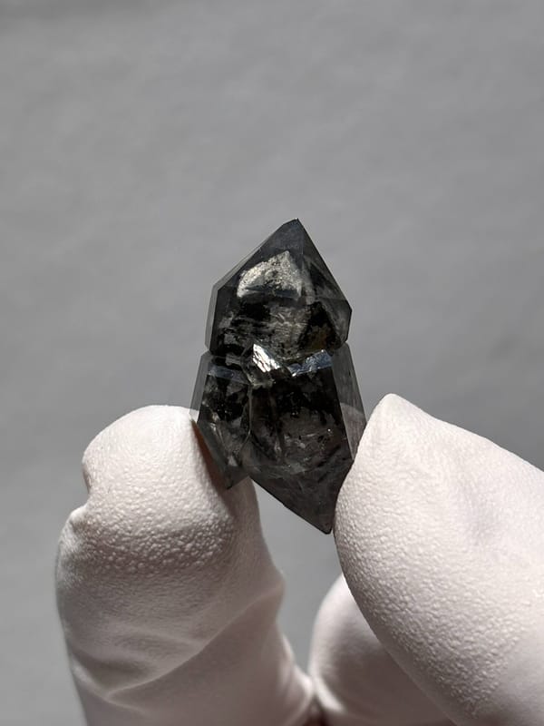 Stout black double-terminated quartz with clear cap from Yunnan, China, close-up of the crystal faces