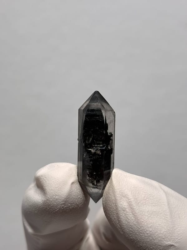 Black double-terminated quartz with clear tip from Yunnan, China, close-up of the crystal faces