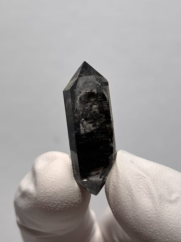 Black double-terminated quartz with clear tip from Yunnan, China, close-up of the crystal faces
