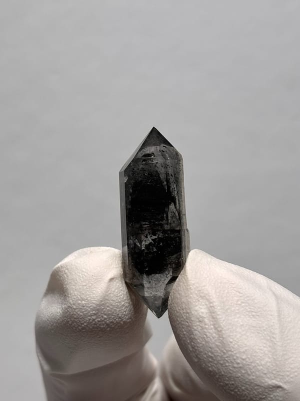 Black double-terminated quartz with clear rim from Yunnan, China, close-up of the crystal faces