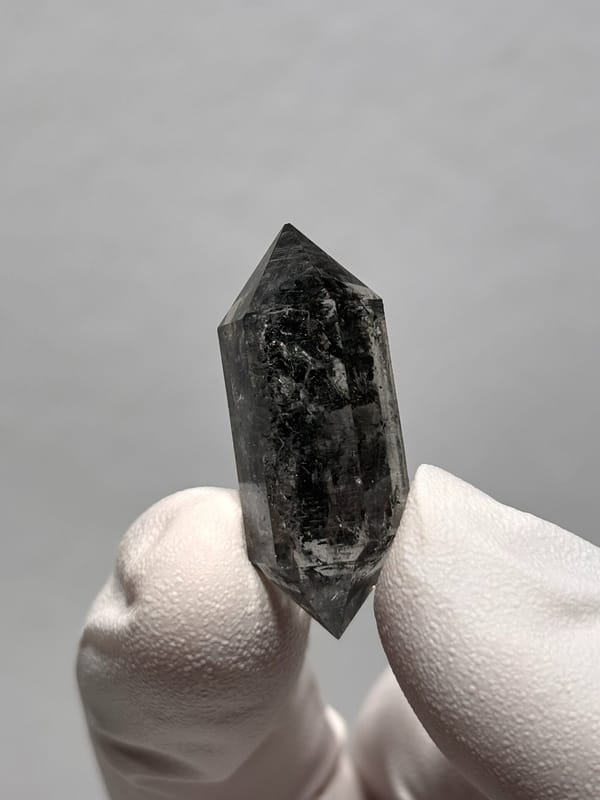 Black double-terminated quartz with clear rim from Yunnan, China, close-up of the crystal faces