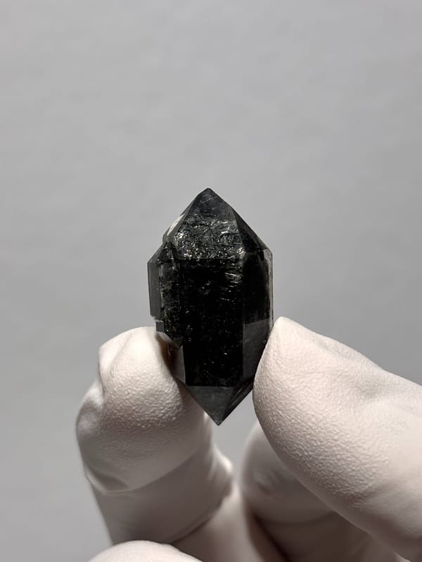 Stout black double-terminated quartz with sparkles from Yunnan, China, close-up of the crystal faces
