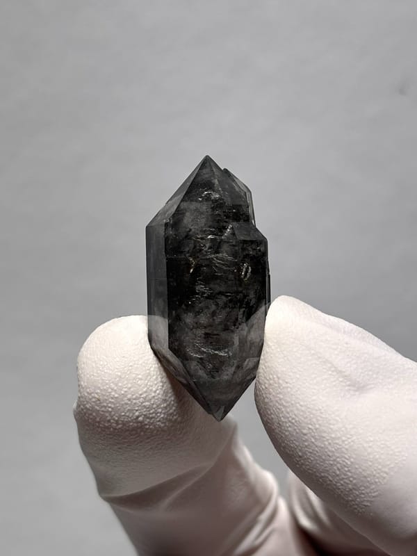 Stout black double-terminated quartz with sparkles from Yunnan, China, close-up of the crystal faces