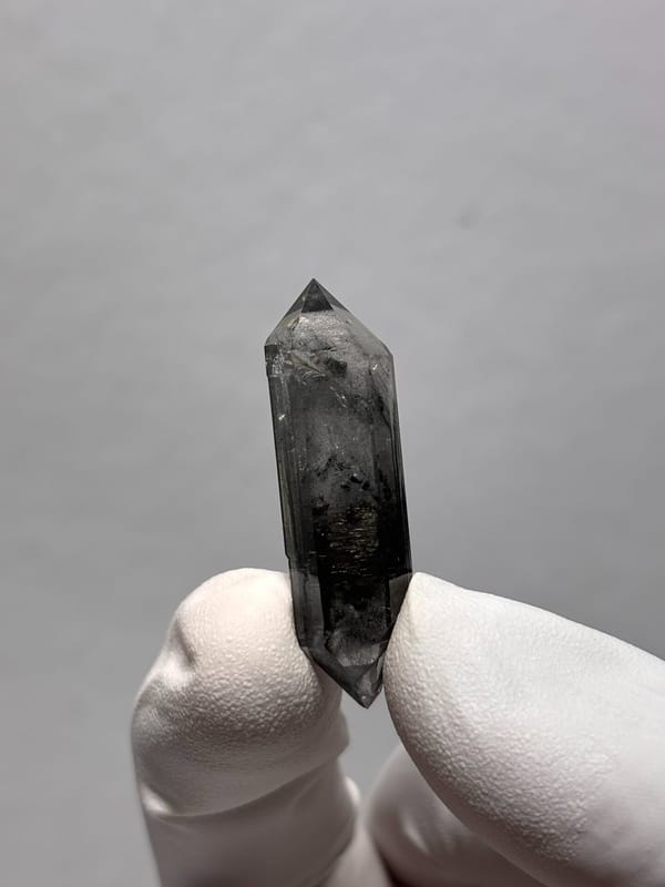Black double-terminated quartz with clear rim from Yunnan, China, close-up of the crystal faces