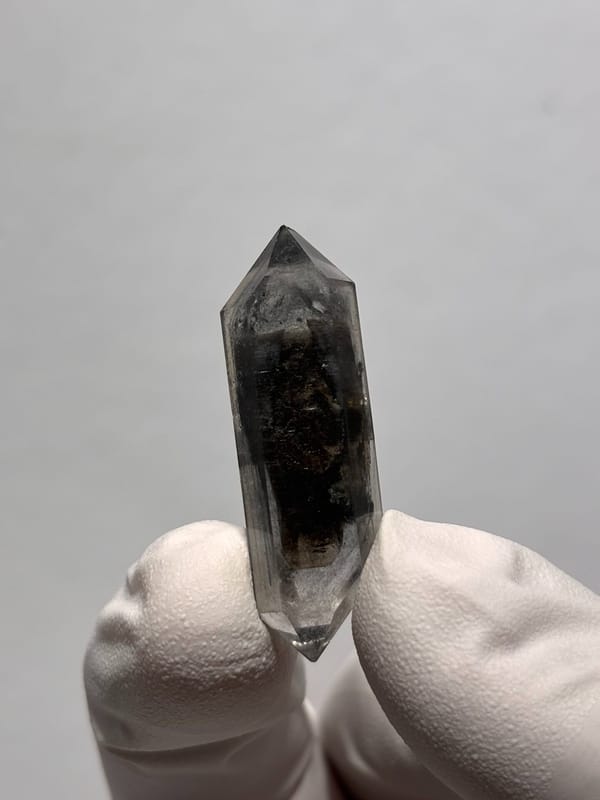 Black double-terminated quartz with clear tip from Yunnan, China, close-up of the crystal faces