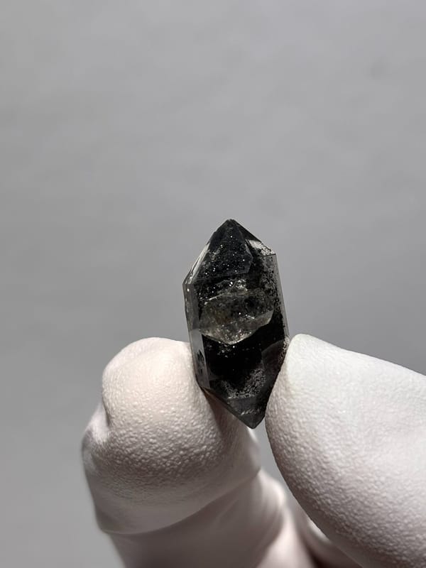 Tiny black double-terminated quartz with side crystal from Yunnan, China, close-up of the crystal faces