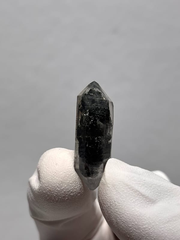 Tiny black double-terminated quartz with clear rim from Yunnan, China, reverse side