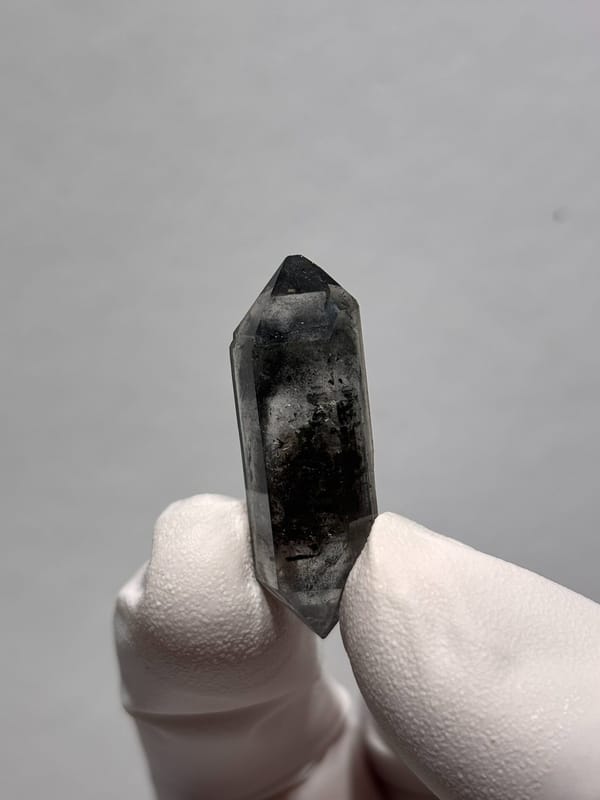 Black double-terminated quartz with clear tip from Yunnan, China, close-up of the crystal faces