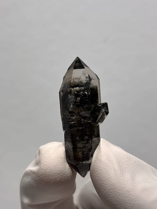 Black double-terminated quartz with golden flecks from Yunnan, China, close-up of the crystal faces
