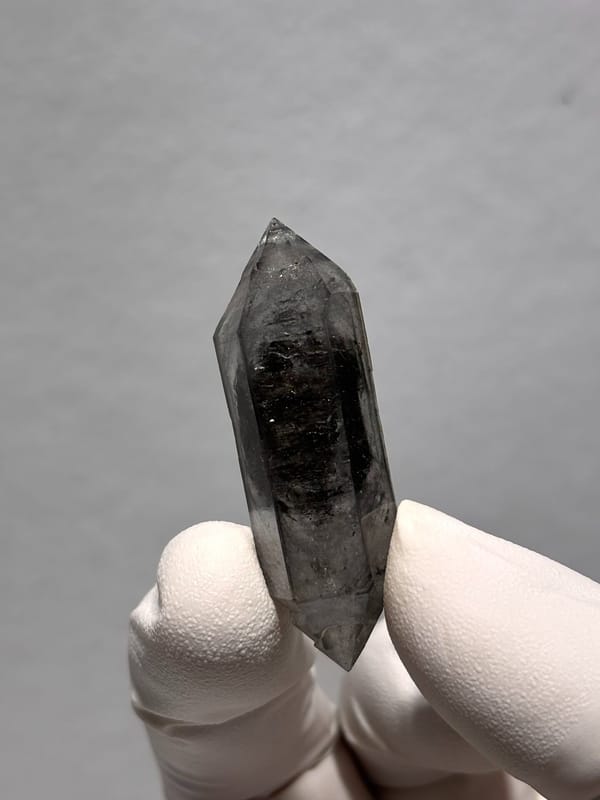 Black double-terminated quartz with clear rim from Yunnan, China, close-up of the crystal faces