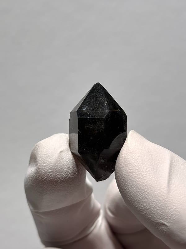 Black sparkly quartz with self-healed tip from Yunnan, China, close-up of the crystal faces