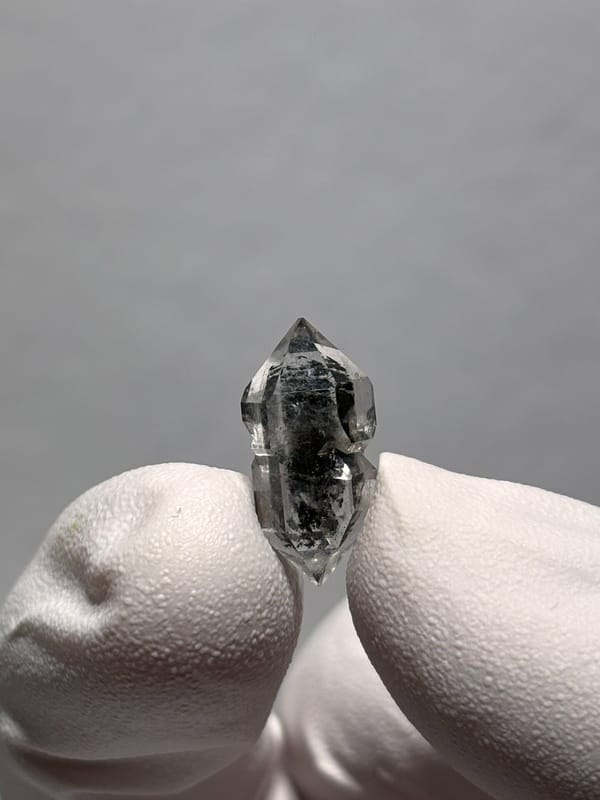 Very tiny black sugar-core double-terminated quartz from Yunnan, China, close-up of the crystal faces