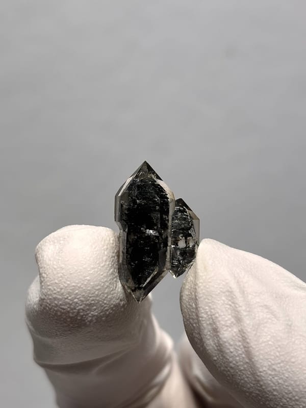 Tiny black sugar-core quartz with side crystal from Yunnan, China, close-up of the crystal faces