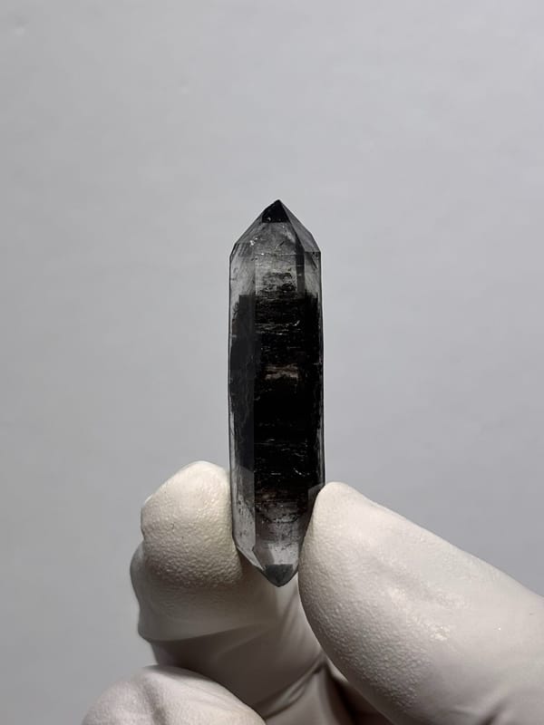 Black sugar-core double-terminated quartz from Yunnan, China, close-up of the crystal faces