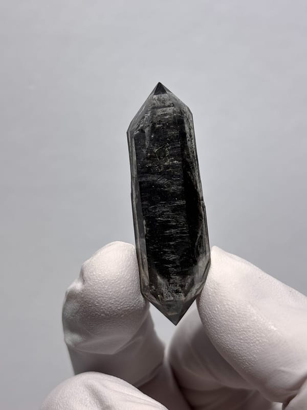 Black sugar-core double-terminated quartz from Yunnan, China, close-up of the crystal faces