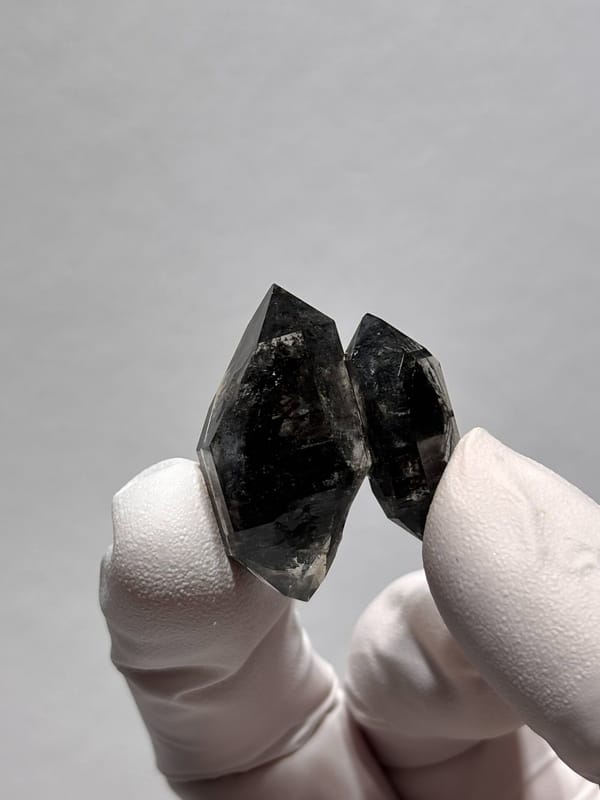 Twinned black double-terminated quartz pair from Yunnan, China, close-up of the crystal faces