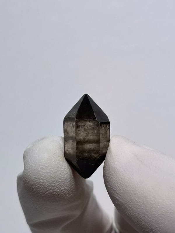 Tiny black-capped double-terminated quartz from Yunnan, China, close-up of the crystal faces