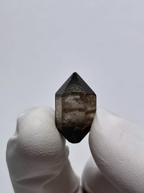 Tiny black-capped double-terminated quartz from Yunnan, China, reverse side
