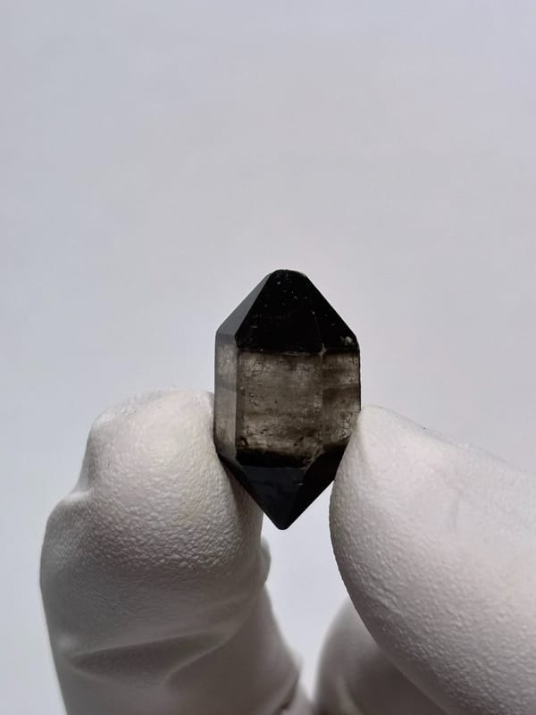 Tiny black-capped double-terminated quartz from Yunnan, China, top view