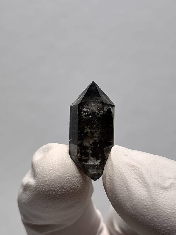 Tiny black-flecked double-terminated quartz from Yunnan, China, second angle