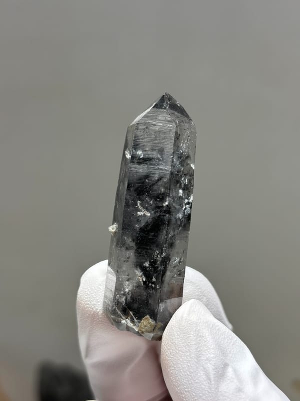Black-included quartz point with rainbow flash from Jinkouhe, Sichuan, China, second angle