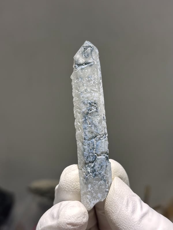 Slender blue-grey quartz wand with complete tip from Inner Mongolia, China, second angle