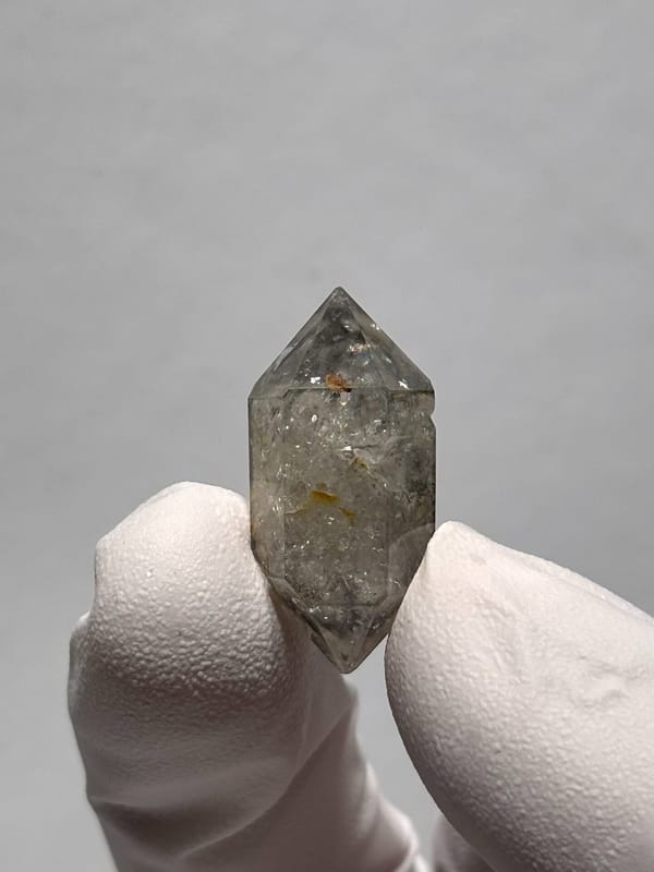 Tiny burst-crystal double-terminated quartz with golden flecks from Yunnan, China, close-up of the crystal faces