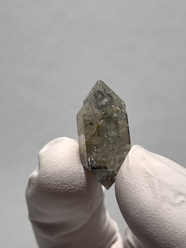 Tiny burst-crystal double-terminated quartz with golden flecks from Yunnan, China, reverse side