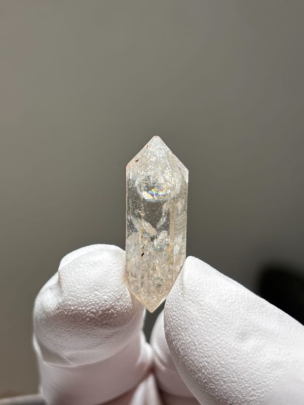 Tiny burst-crystal double-terminated quartz with golden flecks from Yunnan, China, close-up of the crystal faces