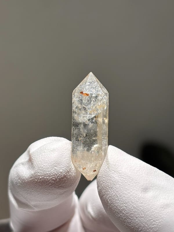 Tiny burst-crystal double-terminated quartz with golden flecks from Yunnan, China, top view