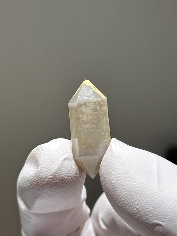 Tiny golden-capped double-terminated quartz from Yunnan, China, close-up of the crystal faces