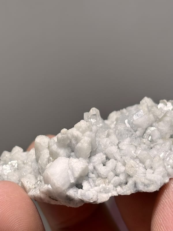 White feldspar plate with pale aquamarine and quartz from Xuebaoding, Sichuan, China, reverse side